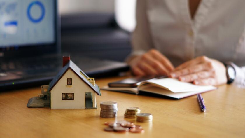 closeup shot person thinking buying selling house » StayBooked