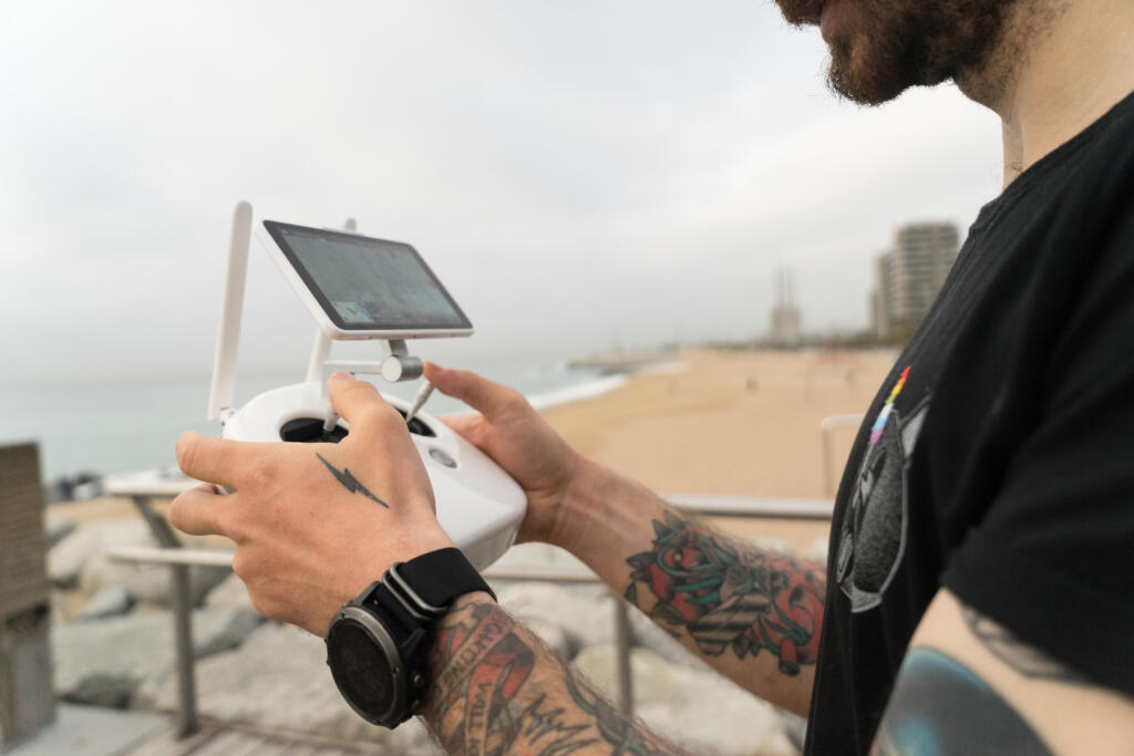 technologically savvy hipster young generation millennial professional photographer uses remote control pilot drone quadrocopter gadget air » StayBooked